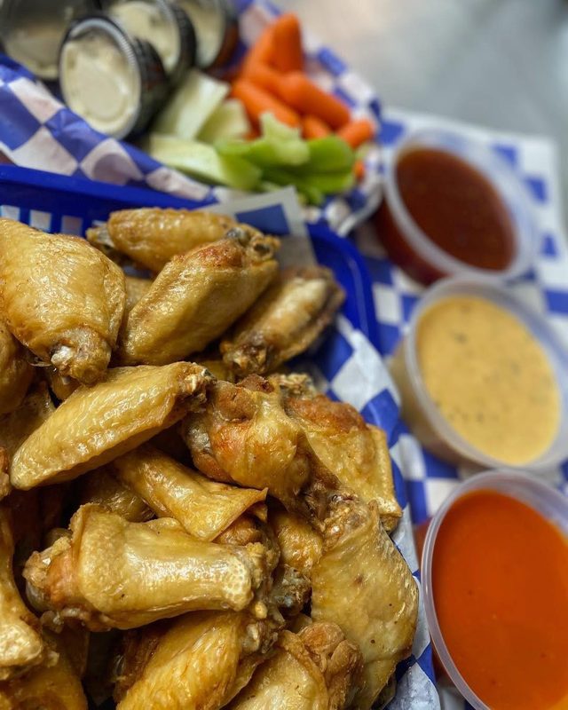Extra crispy golden wings with buffalo sauce, ranch, mustard, celery and carrots